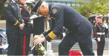  ?? JIM WELLS ?? Fire Chief Steve Dongworth lays a wreath during a City Hall ceremony at City Hall honouring fallen firefighte­rs on Tuesday.