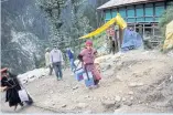  ?? ?? Phula Devi, 30, carries boxes containing vaccine through the village.