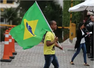  ?? (Sergio Moraes/Reuters) ?? A SUPPORTER of Brazil’s new president-elect, Jair Bolsonaro, celebrates Monday in Rio de Janeiro.