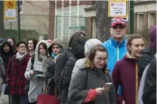  ?? GRAHAM HUGHES/THE CANADIAN PRESS ?? French expats wait in line to vote in Montreal.