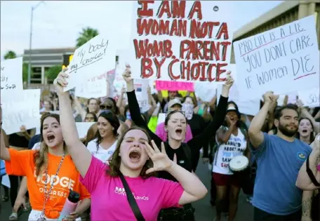  ?? Ross D. Franklin/Associated Press ?? Protesters in Phoenix shout as they join thousands marching around the Arizona state Capitol after the U.S. Supreme Court decision to overturn the landmark Roe v. Wade in June 2022. In a historic decision Tuesday, the Arizona Supreme Court ruled the state must adhere to a 160-year-old law barring all abortions except in cases when “it is necessary to save” a pregnant person’s life.