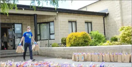  ??  ?? Ruairí Ó Murchú TD who helped prepare Childrens Activity Packs at the Redeemer Family Resource Centre.