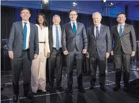  ?? RYAN REMIORZ THE CANADIAN PRESS ?? Candidates Patrick Brown, left, Leslyn Lewis, Scott Aitchison, Pierre Poilievre, Jean Charest and Roman Baber pose for photos after the Frenchlang­uage Conservati­ve Leadership debate Wednesday in Laval, Que.