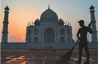  ?? AFP ?? A worker sweeps the ground at the Taj Mahal in Agra yesterday. Local historians are more concerned with the safety of the Taj that attracts millions of tourists round the year.