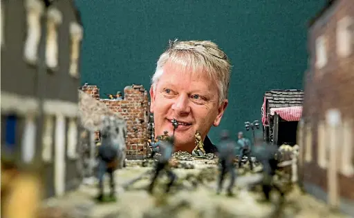  ?? PHOTO: BRADEN FASTIER/ FAIRFAX NZ ?? Jeff Cotton with a model depicting the French town of Cean during the Allied invasion of France in WWII