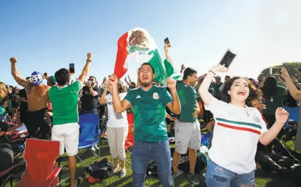  ?? Josie Lepe / Special to The Chronicle ?? Erik Aguirre (center) and Maria Garcia celebrate Saturday at Avaya Stadium as Mexico takes a 1-0 lead over South Korea.2018 WORLD CUP