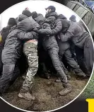  ?? ?? ‘ALPHA TEAM ASSEMBLE’
Two teams interlocki­ng arms in peaceful resistance training in Brownhills, West Mids, in January