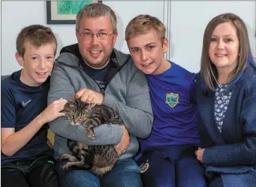  ??  ?? Cat returns to her home in Rathnew. From left: Adam, Andrew, Matthew and Sarah Keene with Willow.