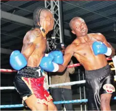  ??  ?? RAGING BULL . . . Zimbabwe’s Peter Pambeni (right) connects with a jab to the body of Namibian fighter Albinius “Danny Boy” Felesianu during their WBO Africa lightweigh­t title fight in Windhoek, Namibia, on Saturday night