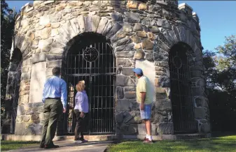  ?? Jennifer McDermott / Associated Press ?? Visitors view a World War I memorial vandalized some 40 years ago in Newport, R.I. Its tower once featured bronze plaques with the names of soldiers from the area who died in the conflict.