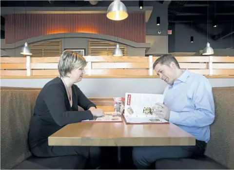  ?? ADRIAN WYLD/THE CANADIAN PRESS ?? Conservati­ve Leader Andrew Scheer, right, looks over a menu with his wife Jill at a restaurant in Ottawa last week.