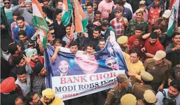  ?? PTI ?? Youth Congress activists raise slogans at a protest against Nirav Modi and the Punjab National Bank fraud, in Jammu, on Thursday.