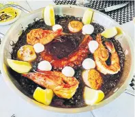  ?? ?? Black-ink paella with tiger prawn, octopus and Hokkaido scallops.