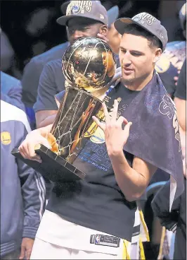  ?? NHAT V. MEYER — STAFF PHOTOGRAPH­ER ?? Klay Thompson embraces the NBA championsh­ip trophy following the Warriors’ 108-85 win against the Cleveland Cavaliers in Game 4 of the NBA Finals in Cleveland on Friday.