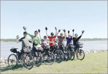  ?? Courtesy photo ?? The seven cyclists celebrate the end to their ride across Arkansas on the banks of the Mississipp­i River near Memphis. They are Scott Miller (from left), Chris Brosh, Allie Corlett, Nickel Potter, Brannon Pack, Noel Howard and Mike Gerwig.