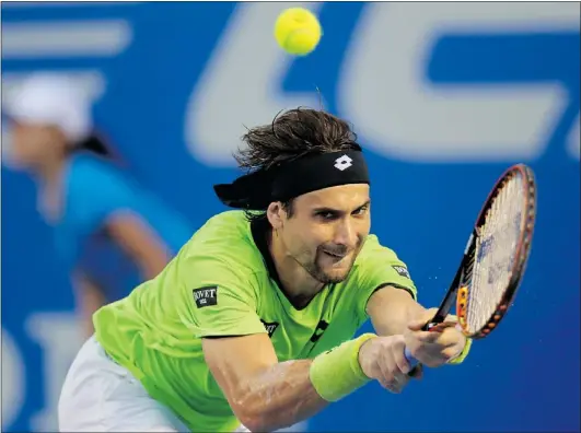  ?? — GETTY IMAGES ?? Top-seeded David Ferrer of Spain returns the ball to fellow Spaniard Feliciano Lopez during the Mexico ATP Open men’s single tennis match, in Acapulco, Mexico on Wednesday. Ferrer won the match 7-6 (1), 7-2 to advance to the quarter-finals.