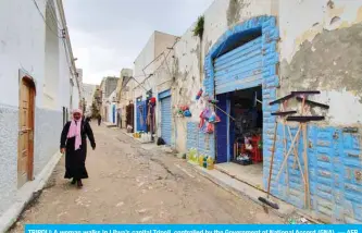  ??  ?? TRIPOLI: A woman walks in Libya’s capital Tripoli, controlled by the Government of National Accord (GNA). — AFP