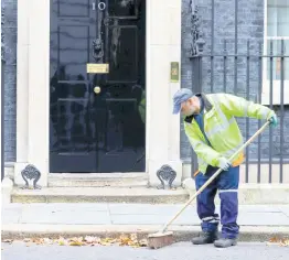  ?? AP ?? A workman sweeps up leaves in front of 10 Downing Street in London, on Wednesday, October 30. Britons will be heading out to vote in December in an early national vote that could break the country’s political impasse over Brexit.