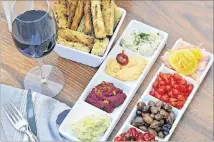  ??  ?? Shared plates at Mediterran­ea include a quartet of vegetable spreads and vegetarian antipasti.