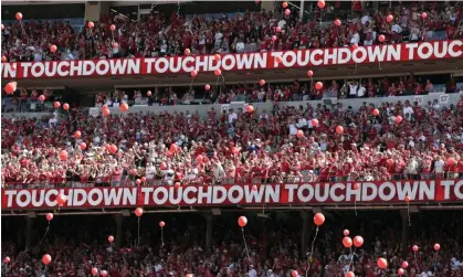  ?? Photograph: Nati Harnik/AP ?? Nebraska Cornhusker­s fans release red balloons after a touchdown in 2018. The team announced that it had to suspend its traditiona­l touchdown celebratio­n of red balloons.