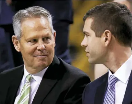  ?? THE ASSOCIATED PRESS FILE PHOTO ?? Celtics general manager Danny Ainge, left, talks with Celtics coach Brad Stevens.