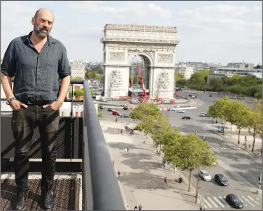  ??  ?? Vladimir Yavachev, a nephew of Christo and who leads the “L’Arc de Triomphe, Wrapped” project, poses Aug. 24 near at the Arc de Triomphe.