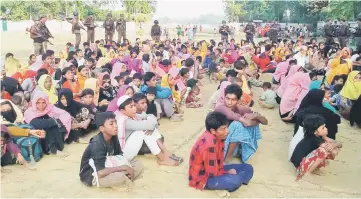  ?? — AFP photo ?? File photo shows Rohingya Muslims from Myanmar, who tried to cross the Naf river into Bangladesh to escape sectarian violence, being kept under watch by Bangladesh­i security officials in Teknaf. In squalid camps in Bangladesh, hundreds of thousands of...