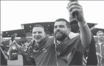  ?? AP ?? Wrexham's Paul Mullin and Elliot Lee celebrate promotion to League One after beating Forest Green 6-0 in a Sky Bet League Two match at the SToK Cae Ras, Wrexham, on Saturday.