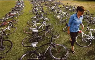  ??  ?? Laura Robert on Friday looks for her bike among many from Austin at Darrell Tully Stadium. She has made the BP MS 150 charity ride every year since 1995. Volunteers and dedicated cyclists like Robert make up the backbone of the annual event.