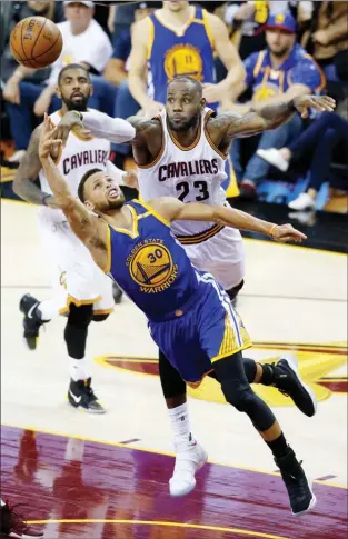  ?? The Associated Press ?? Golden State Warriors guard Stephen Curry shoots in front of Cleveland Cavaliers forward LeBron James during the second half of Game 3 of basketball's NBA Finals in Cleveland on Wednesday.