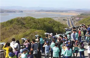  ?? AP Photo/Ahn Young-joon ?? ■ Visitors watch the North Korea side from the unificatio­n observator­y Saturday in Paju, South Korea, near the border with North Korea.