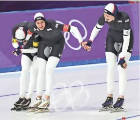  ??  ?? Mia Manganello, left, Brittany Bowe, center, and Heather Bergsma celebrate after winning bronze in the women’s team pursuit. ANDREW P. SCOTT/USA TODAY SPORTS