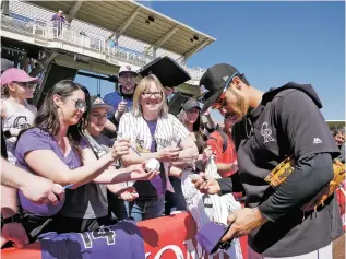  ?? MATT DAHLSEID/NEW MEXICAN FILE PHOTO ?? Colorado Rockies third baseman Nolan Arenado signs autographs for fans prior to an exhibition game in March 2019 against the Isotopes at Isotopes Park.