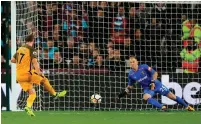  ??  ?? Glenn Murray rolls his late penalty past goalkeeper Joe Hart during Brighton’s victory over West Ham