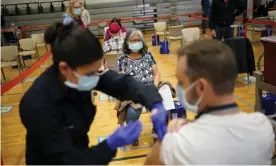  ??  ?? People receive the Covid-19 vaccine at a vaccinatio­n site in Las Vegas in February. Photograph: John Locher/AP
