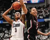  ?? Jessica Hill/Associated Press ?? UConn’s Aaliyah Edwards (3) shoots as South Carolina’s Victaria Saxton defends in the first half Sunday in Hartford.