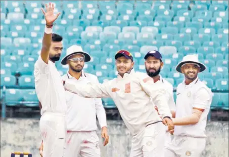  ?? ANI ?? ■ Saurashtra captain Jaydev Unadkat (left) has picked 65 wickets and is three shy of the all-time record, set by Bihar spinner Ashutosh Aman last season.