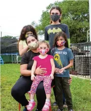  ?? DANIEL A. VARELA dvarela@miamiheral­d.com ?? Single mother Kandy Gomez, 39, sits with her kids Christian Arias, 13, Jeslin Arias, 10, Gabriel Gomez, 7, and Brianna Alvarado, 2, outside their house in Liberty City on Nov. 21.