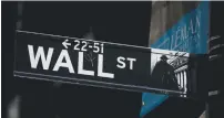  ?? (Brendan McDermid/Reuters) ?? A WALL STREET sign is seen near the New York Stock Exchange.