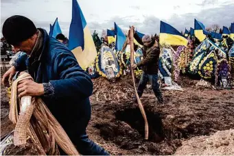  ?? Daniel Berehulak/New York Times ?? Cemetery workers bury the coffin of Ukrainian soldier Oleksiy Lytvynov during his funeral Sunday in Boryspil near Kyiv, Ukraine.