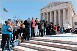  ?? J. SCOTT APPLEWHITE/AP ?? Visitors wait outside the Supreme Court, where the court split on the union case Tuesday.