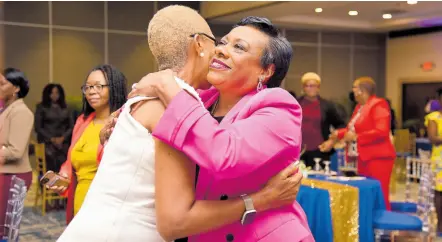  ?? ANTOINE LODGE/ PHOTOGRAPH­ER ?? Rebecca Pringle (right), president of the National Education Associatio­n in the United States, embraces Fayval Williams, minister of education and youth, during the Jamaica Teachers’ Associatio­n Status of Women Conference, held at The Jamaica Pegasus hotel in New Kingston yesterday.