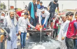  ?? PTI ?? ▪ Farmers spill milk on the road during a protest in Haryana’s Hisar on Friday.