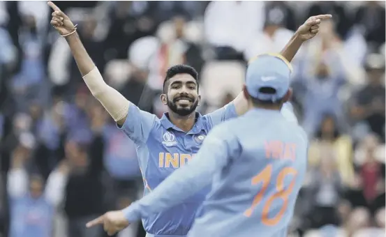  ??  ?? 2 Jasprit Bumrah celebrates with captain Virat Kohli after dismissing South Africa’s Hashim Amla as India made a winning start to their World Cup campaign at the Hampshire Bowl.