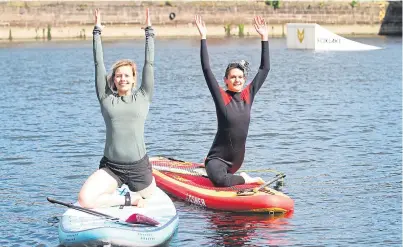  ??  ?? Owner of Sattva Wellness and Sup yoga teacher Michaella Robb, left, and Nadia on their paddleboar­ds. Picture: Mhairi Edwards.