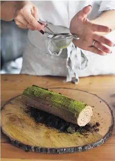  ??  ?? Decorate the bûche de Noël with a dusting of cocoa powder and matcha tea powder to resemble a mossy log.