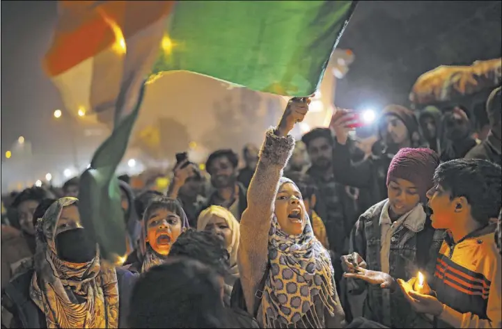  ?? Altaf Qadri The Associated Press ?? A young girl waves the Indian national flag as she shouts slogans during a demonstrat­ion Tuesday in the Shaheen Bagh neighborho­od of New Delhi, India.