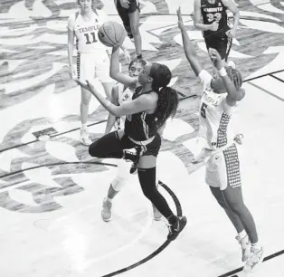  ?? COURTESY OF JACQUELINE TERPAK / TEMPLE ATHLETICS ?? UCF guard Diamond Battles drives past two Temple defenders Saturday on her way to the basket during the Knights’ 68-31 victory.