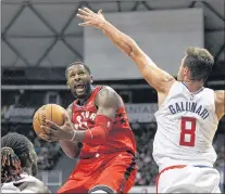  ?? CP PHOTO ?? Toronto Raptors forward C.J. Miles (left) goes towards the basket as Los Angeles Clippers forward Danilo Gallinari tries to guard him during the third quarter of a preseason NBA game Sunday in Honolulu.