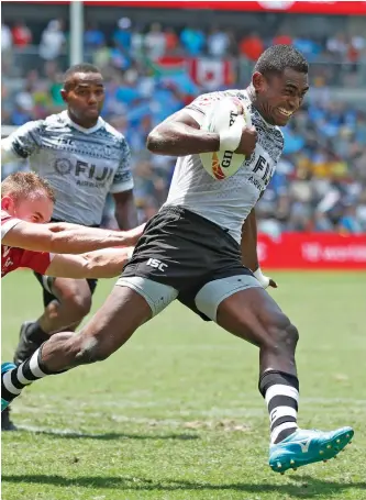  ?? Photo: World Rugby ?? Fiji Airways Fijian 7s winger Aminiasi Tuimaba bursts through the Wales defence during the Sydney Sevens in their final pool game. Fiji won 55-0.